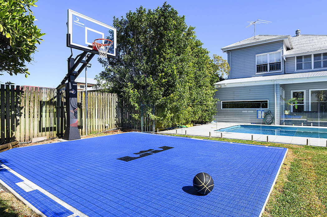 backyard basketball court in Brisbane next to a pool